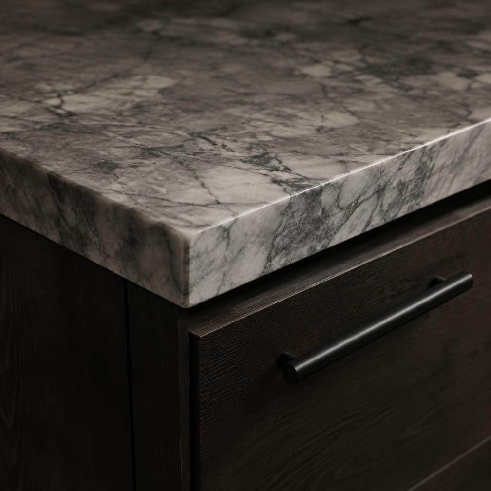 Mitered stone countertop edge over dark cabinetry